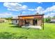 Expansive backyard featuring a cozy pergola, a table with chairs, and a sliding door for indoor-outdoor living at 6842 Sextant Dr, Indianapolis, IN 46260