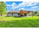 Lush backyard featuring a covered pergola with a table and chairs for outdoor enjoyment at 6842 Sextant Dr, Indianapolis, IN 46260
