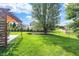 Large backyard with a fire pit and a covered pergola with outdoor seating at 6842 Sextant Dr, Indianapolis, IN 46260