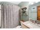Cozy bathroom featuring soft colors, a shower with a whale-themed curtain, and floating shelves for storage at 6842 Sextant Dr, Indianapolis, IN 46260