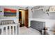 Bright Bedroom featuring neutral walls, a rocking chair, a crib, and a dresser for easily accessible storage at 6842 Sextant Dr, Indianapolis, IN 46260