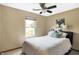 Cozy bedroom featuring neutral walls, a queen bed, and a window for natural light and a ceiling fan at 6842 Sextant Dr, Indianapolis, IN 46260