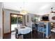 Dining area with seating, modern lighting, and patio access at 6842 Sextant Dr, Indianapolis, IN 46260