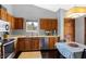 Well-lit kitchen featuring wooden cabinets, stainless steel appliances, and an adjacent dining area at 6842 Sextant Dr, Indianapolis, IN 46260