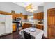 Charming kitchen featuring wood cabinets, stainless appliances, and a cozy eat-in dining space at 6842 Sextant Dr, Indianapolis, IN 46260