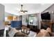 Open-concept living room with dark floors, leading into the kitchen with stainless steel appliances at 6842 Sextant Dr, Indianapolis, IN 46260