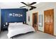 Spacious bedroom with ceiling fan, adjoining bathroom, and a large comfortable bed at 6842 Sextant Dr, Indianapolis, IN 46260