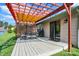 Outdoor patio featuring a wooden pergola, a table with seating, and access to a backyard at 6842 Sextant Dr, Indianapolis, IN 46260