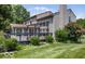 Lush backyard with a sunroom, deck, and mature landscaping, creating a private outdoor retreat at 7211 Topp Creek Ct, Indianapolis, IN 46214