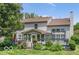 Expansive backyard featuring a deck, sunroom, manicured lawn, and mature trees, ideal for outdoor living at 7211 Topp Creek Ct, Indianapolis, IN 46214