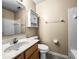 Bathroom featuring neutral walls, wood vanity with sink, toilet, and shower/tub with shower head at 7211 Topp Creek Ct, Indianapolis, IN 46214
