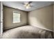 Bedroom features neutral carpet and walls, a ceiling fan and a window that allows ample natural light at 7211 Topp Creek Ct, Indianapolis, IN 46214