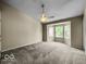 Bedroom features neutral carpet and walls, a ceiling fan and a bay window that allows ample natural light at 7211 Topp Creek Ct, Indianapolis, IN 46214