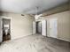 Bedroom features neutral carpet and walls, a ceiling fan and access to a full bathroom with tub and shower at 7211 Topp Creek Ct, Indianapolis, IN 46214