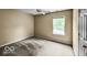 Bedroom features neutral carpet and walls, a ceiling fan and a window that allows ample natural light at 7211 Topp Creek Ct, Indianapolis, IN 46214