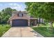 Charming two-story home with brick accents, mature trees, and a well-manicured lawn at 7211 Topp Creek Ct, Indianapolis, IN 46214