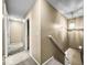 Well-lit hallway featuring neutral walls, carpet flooring, and a staircase leading to the upper level of the home at 7211 Topp Creek Ct, Indianapolis, IN 46214