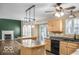 Open concept kitchen with center island and view to living area with fireplace at 7211 Topp Creek Ct, Indianapolis, IN 46214