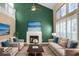 Bright living room featuring a fireplace, tall windows, soaring ceilings, and comfortable beige furniture at 7211 Topp Creek Ct, Indianapolis, IN 46214