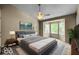 Spacious main bedroom features a large bed, neutral color palette, bay windows, and modern lighting at 7211 Topp Creek Ct, Indianapolis, IN 46214
