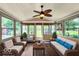 Charming sunroom with ample windows offering beautiful outdoor views and a relaxing seating area at 7211 Topp Creek Ct, Indianapolis, IN 46214