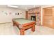 Basement game room with a pool table and brick fireplace at 7220 Normandy Way, Indianapolis, IN 46278