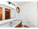 Bathroom featuring a vanity with solid surface counters, a toilet, a decorative window and tiled floors at 7220 Normandy Way, Indianapolis, IN 46278