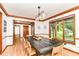 Bright dining room featuring wood floors, trim detail, and a view of the manicured lawn at 7220 Normandy Way, Indianapolis, IN 46278