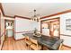 Bright dining room featuring wood floors, trim detail, and modern light fixture at 7220 Normandy Way, Indianapolis, IN 46278