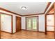 Open foyer featuring wood floors, attractive trim, and double doors with glass inserts at 7220 Normandy Way, Indianapolis, IN 46278