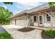 Charming home featuring a three-car garage and beautifully landscaped front yard with brick facade at 7220 Normandy Way, Indianapolis, IN 46278