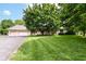 Charming brick home featuring a well-manicured lawn and mature trees enhancing its curb appeal at 7220 Normandy Way, Indianapolis, IN 46278