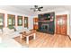 Comfortable living room featuring a fireplace, a soft sofa, and a view to the backyard at 7220 Normandy Way, Indianapolis, IN 46278