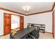 This carpeted office space features wood doors, a dark desk, and a bookcase for storage and organization at 7220 Normandy Way, Indianapolis, IN 46278