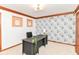 This office features neutral carpet, decorative crown moulding, and a statement floral wallpaper on one wall at 7220 Normandy Way, Indianapolis, IN 46278