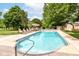 Backyard oasis with a sparkling pool, lounge chairs, and manicured landscaping for ultimate relaxation at 7220 Normandy Way, Indianapolis, IN 46278
