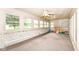 Inviting sun room with multiple windows, and brick accent walls at 7220 Normandy Way, Indianapolis, IN 46278
