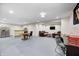 Open-concept finished basement features painted floors, recessed lighting and TV area at 749 Bracknell Dr, Avon, IN 46123