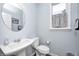 Well-lit bathroom with pedestal sink, toilet, and window at 749 Bracknell Dr, Avon, IN 46123