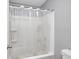 Bright bathroom features a shower-tub combo with white tile surround and a clear shower curtain at 749 Bracknell Dr, Avon, IN 46123