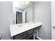 Bathroom vanity features a white countertop, dark cabinets and large mirror at 749 Bracknell Dr, Avon, IN 46123
