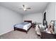 This comfortable bedroom features a ceiling fan, neutral decor and a dark-wood desk at 749 Bracknell Dr, Avon, IN 46123