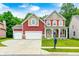 Charming two-story home featuring a well-manicured lawn and a spacious three-car garage at 749 Bracknell Dr, Avon, IN 46123