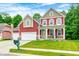 Charming two-story home with well-manicured lawn and mature landscaping at 749 Bracknell Dr, Avon, IN 46123