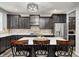 Well-lit kitchen boasts dark wood cabinetry, stainless steel appliances, and an island at 749 Bracknell Dr, Avon, IN 46123