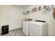 Well-equipped laundry room with modern washer and dryer units and ample shelving at 749 Bracknell Dr, Avon, IN 46123