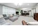Open-concept living room showcasing a plush gray sectional sofa, fireplace, and view into the kitchen at 749 Bracknell Dr, Avon, IN 46123