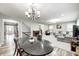 Open-concept living space showcasing a dining area, living room, and view of the foyer and staircase at 749 Bracknell Dr, Avon, IN 46123