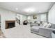 Large living room featuring a cozy fireplace, comfortable sectional sofa, and bright windows at 749 Bracknell Dr, Avon, IN 46123