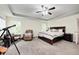 Bright main bedroom featuring a comfy chair, telescope, and a large bed with stylish furnishings at 749 Bracknell Dr, Avon, IN 46123